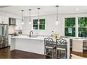 Modern kitchen with stainless steel appliances, white countertops, and stylish pendant lighting at 68 Peachtree Memorial Nw Dr # 68-1, Atlanta, GA 30309