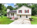 Charming split-level home with red shutters and a well-maintained front yard at 132 Bishop Nw Rd, Cartersville, GA 30121