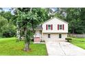 Inviting split-level home with red shutters surrounded by lush greenery at 132 Bishop Nw Rd, Cartersville, GA 30121