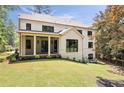Beautiful home featuring a covered outdoor patio with ceiling fans and a spacious backyard at 3292 Lenox Ne Pl, Atlanta, GA 30324