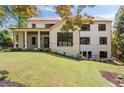 This home features a covered back porch with multiple windows, great for entertaining at 3292 Lenox Ne Pl, Atlanta, GA 30324