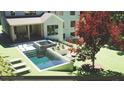 Captivating backyard with a modern pool, integrated hot tub, and cozy lounge areas for ultimate relaxation at 3292 Lenox Ne Pl, Atlanta, GA 30324