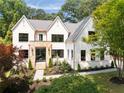 Beautifully landscaped two-story home with a brick exterior, stone entryway and black trim windows at 3292 Lenox Ne Pl, Atlanta, GA 30324