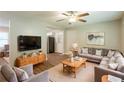 Cozy living room with modern decor featuring a ceiling fan, hardwood floors, and an L-shaped sofa with decorative pillows at 6662 Birchwood Ct, Winston, GA 30187