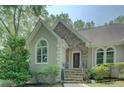 Inviting front entrance with stone accents, arched windows, and well-maintained landscaping at 13935 Brown Bridge Rd, Covington, GA 30016