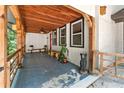 Inviting front porch with wood ceiling, charming decor, and natural wood columns at 4025 Demooney Rd, Atlanta, GA 30349