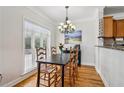 Bright dining room with natural light, hardwood floors and modern chandelier at 2465 Main St # 201, Atlanta, GA 30344