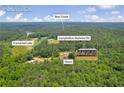 Aerial view of home near Carmel Lake and Bear Creek, offering a serene environment surrounded by nature in Palmetto, GA at 6160 Campbellton Redwine Rd, Chattahoochee Hills, GA 30268
