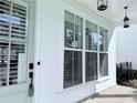 Close up of the front porch with large windows, a secure door, and modern hanging lights at 992 Harvest Park Ln, Suwanee, GA 30024