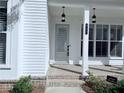 View of the front door and porch with brick and hanging lights at 992 Harvest Park Ln, Suwanee, GA 30024