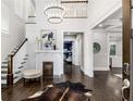 Grand two-story entry foyer featuring beautiful hardwood floors, a decorative fireplace, and a statement chandelier at 327 6Th Ne St, Atlanta, GA 30308