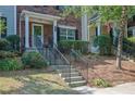 Attractive brick townhome with a welcoming front porch and well-maintained landscaping at 833 Society Ct, Woodstock, GA 30188