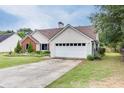 Charming home with a well maintained lawn and two car garage at 992 Harbins Pass Dr, Dacula, GA 30019