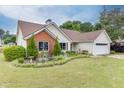 Charming single-story home with well-manicured lawn and landscaping at 992 Harbins Pass Dr, Dacula, GA 30019