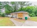 Charming single-story home with a well-maintained lawn and paved walkway at 1421 Dennis Dr, Decatur, GA 30032