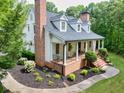 Beautifully landscaped yard, classic white columns, and brick accents enhance this elegant home's curb appeal at 5588 Rhododendron Trl, Douglasville, GA 30135
