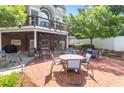 A brick patio with several tables and chairs with trees in the background at 2910 Leeds Garden Ln, Alpharetta, GA 30022