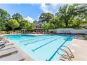 A large pool with lounge chairs, a building, and the 'Chartwell' sign in the background at 2910 Leeds Garden Ln, Alpharetta, GA 30022