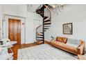 Inviting living room with spiral staircase, hardwood floors, and a cozy seating area at 30 5Th Ne St # 1006, Atlanta, GA 30308