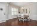 Bright dining room featuring hardwood floors, wainscoting, and stylish lighting at 4840 Chase Ln, Cumming, GA 30040