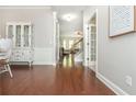 Elegant entryway showcasing hardwood floors and views into the staircase and living spaces at 4840 Chase Ln, Cumming, GA 30040
