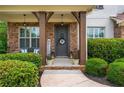 Inviting front porch with stone facade, decorative wreath, and landscaped surroundings at 4840 Chase Ln, Cumming, GA 30040