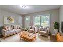Cozy living room with neutral decor, soft lighting, and large window at 1539 Pine Glen Cir, Decatur, GA 30035
