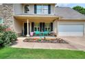 Charming front porch with colorful seating and landscaping, creating a welcoming entrance at 2314 Robin Dr, Loganville, GA 30052