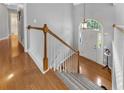 Bright foyer with hardwood floors, staircase, and view of the front door at 100 Chestnut Hill Dr, Canton, GA 30114