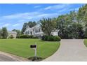 Suburban home featuring a long driveway and a neatly kept front lawn at 100 Chestnut Hill Dr, Canton, GA 30114