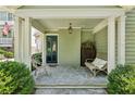 Inviting front porch with stone flooring, seating, and classic decor at 111 Terrace Ne Dr, Atlanta, GA 30305