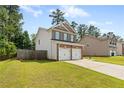 Two-story home with brick and siding, a two-car garage, and a well-kept lawn in a suburban setting at 154 Stephens Mill Dr, Dallas, GA 30157