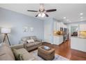 Cozy living room with hardwood floors, ceiling fan, and view to the kitchen area at 2245 Long Bow Chase, Kennesaw, GA 30144
