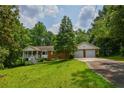 Charming single-Gathering home with a brick facade, inviting front porch, two-car garage, and a lush green lawn at 3223 Heritage Way, Buford, GA 30519