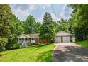 Charming single-Gathering home with a brick facade, inviting front porch, two-car garage, and a lush green lawn at 3223 Heritage Way, Buford, GA 30519