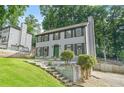 Classic two-story home with green front door, set on a landscaped lot with mature trees and a driveway at 998 Pointer Rdg, Tucker, GA 30084