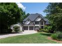 Beautiful two-story home with a well-manicured lawn, attached garage, and inviting curb appeal at 1515 Lockridge Dr, Cumming, GA 30041