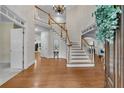 Grand foyer featuring hardwood floors, a chandelier, and a staircase with white railings at 1548 Valley Reserve Court, Kennesaw, GA 30152