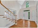 Bright foyer with hardwood floors, and a staircase with white railings at 1548 Valley Reserve Court, Kennesaw, GA 30152
