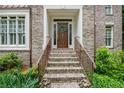 Inviting front entry with brick steps, bronze railings, and a classic wooden door with a wreath at 1548 Valley Reserve Court, Kennesaw, GA 30152