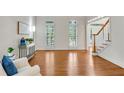 Spacious living room with hardwood floors, large windows, and tasteful decor at 1548 Valley Reserve Court, Kennesaw, GA 30152