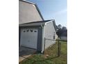 Shot of garage exterior with vinyl siding and an overhead door at 170 Inverness Trce, Riverdale, GA 30274