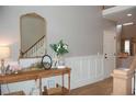 Elegant foyer featuring wainscoting, hardwood floors, and stylish decor at 3145 Sweet Basil Ln, Loganville, GA 30052