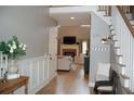 Inviting foyer with hardwood floors, staircase, and view of the living room with fireplace at 3145 Sweet Basil Ln, Loganville, GA 30052