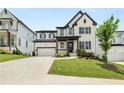 Charming two-story home featuring a spacious driveway, lush lawn, and attractive landscaping at 382 Tillman Pass, Woodstock, GA 30188