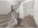 Elegant foyer with hardwood floors, staircase with iron railings, and plenty of natural light at 382 Tillman Pass, Woodstock, GA 30188