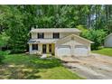 Traditional two-story home with a two-car garage and an expansive front lawn at 1925 Sailcloth St, Lithonia, GA 30058