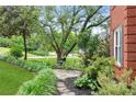 Landscaped side yard with stone pathway leading to an outdoor seating area at 2220 Cape Courage Way, Suwanee, GA 30024