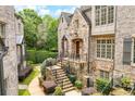 Beautiful stone and brick home with manicured landscaping and a charming walkway at 4853 Stonehall Pl, Atlanta, GA 30339