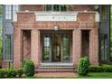 Elegant brick home entrance showcasing glass paned double doors and stone address plate at 1026 Reeder N Cir, Atlanta, GA 30306